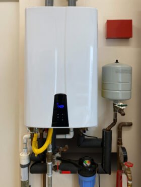 Tankless water heater mounted on wall of a San Antonio home