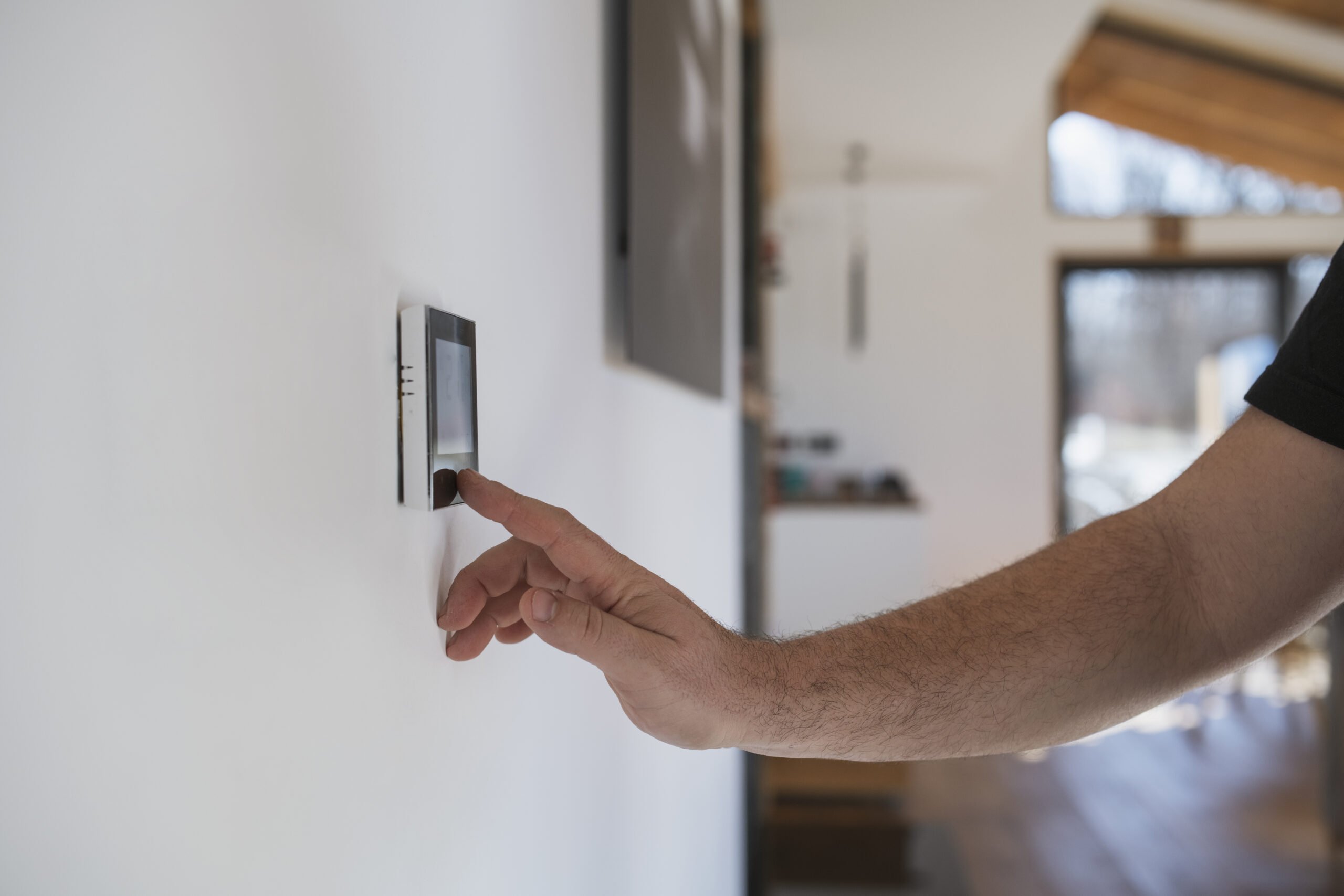 Homeowner adjusting thermostat